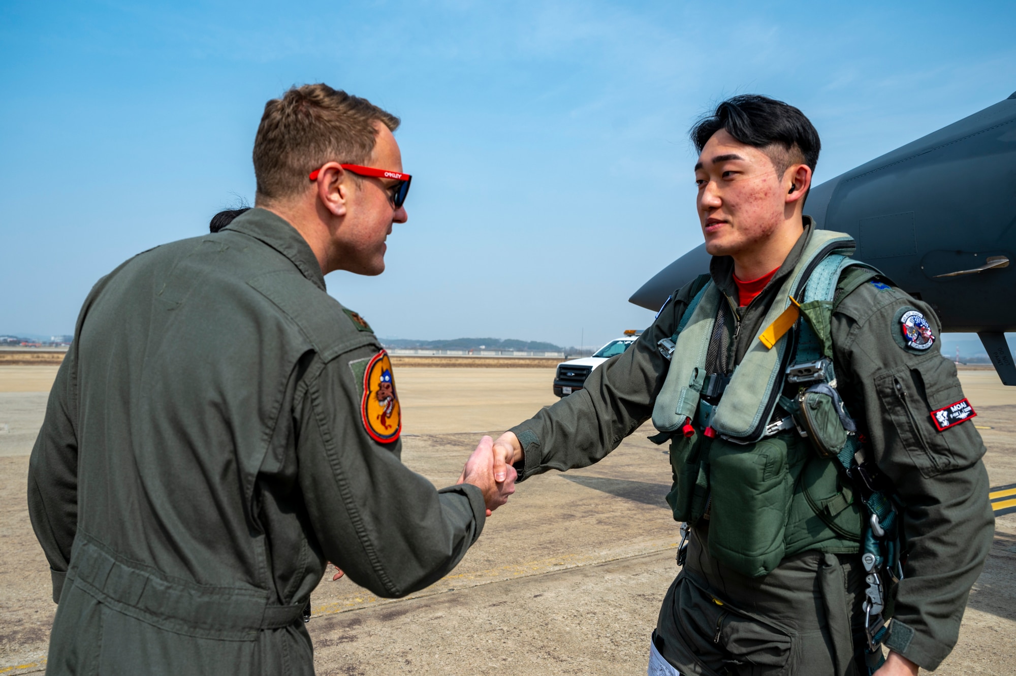 U.S. Air Force Major. Matthew Elliot, 36th Fighter Squadron assistant director of operations, greets Republic of Korea Air Force Capt. Jeongwook Lee, 122nd FS F-15 pilot, during Buddy Squadron 24-2 at Osan Air Base, Republic of Korea, March 4, 2024. BS 24-2 is the first iteration  to include more personnel outside of air crew and maintenance members. The Buddy Squadron Program fosters objective-based training and improves interoperability between the U.S. and ROKAF fighter squadrons. (U.S. Air Force photo by Senior Airman Kaitlin Frazier)