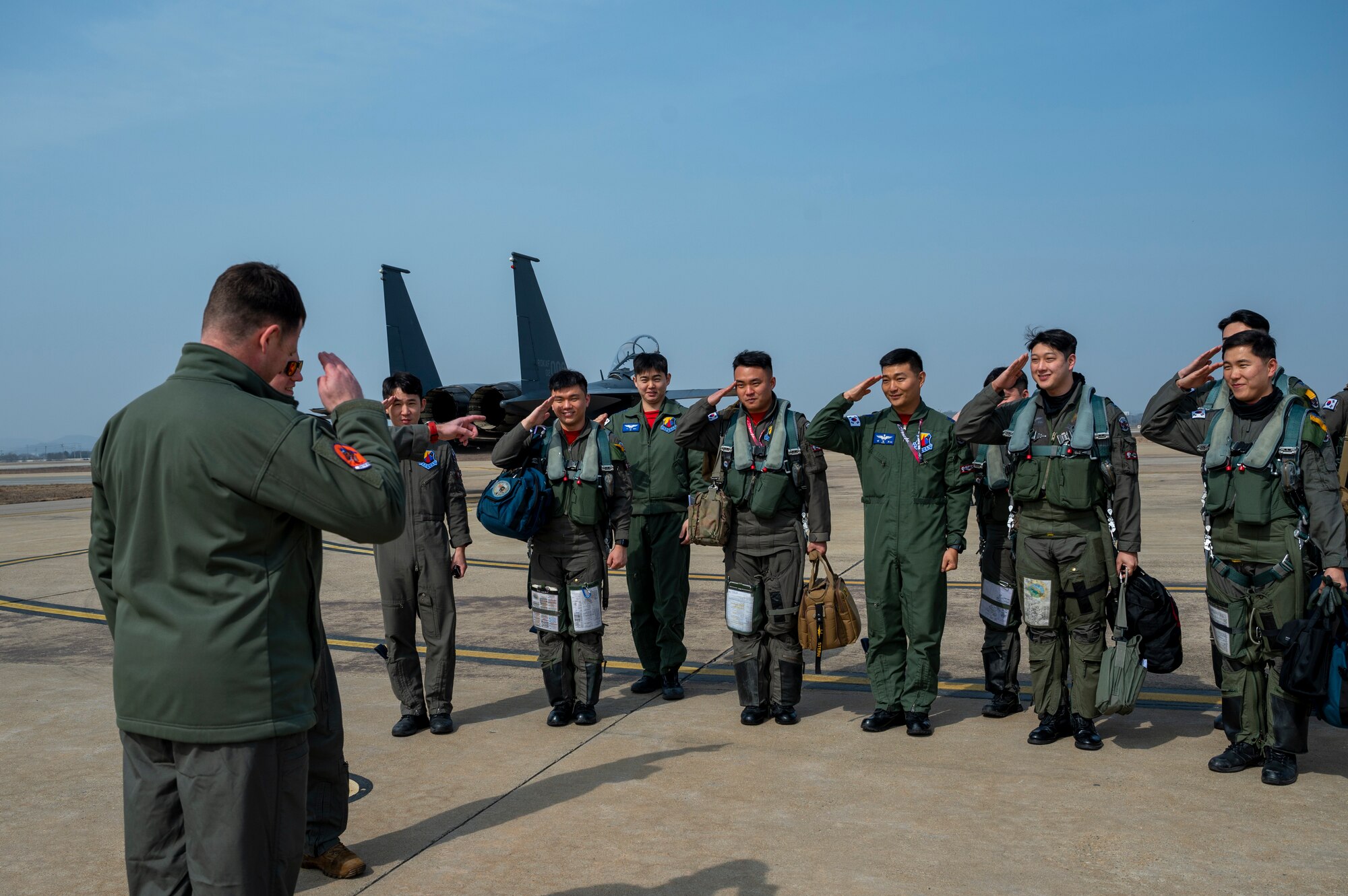 Republic of Korea Air Force pilots assigned to the 122nd Fighter Squadron salutes U.S. Air Force Lt. Col. Cory Farrer, 36th FS commander, during Buddy Squadron 24-2 at Osan Air Base, Republic of Korea, March 4, 2024. The USAF and ROKAF have been training together through the Buddy Squadron Program for more than 20 years. The Buddy Squadron Program fosters objective-based training and improves interoperability between the U.S. and ROKAF fighter squadrons. (U.S. Air Force photo by Senior Airman Kaitlin Frazier)