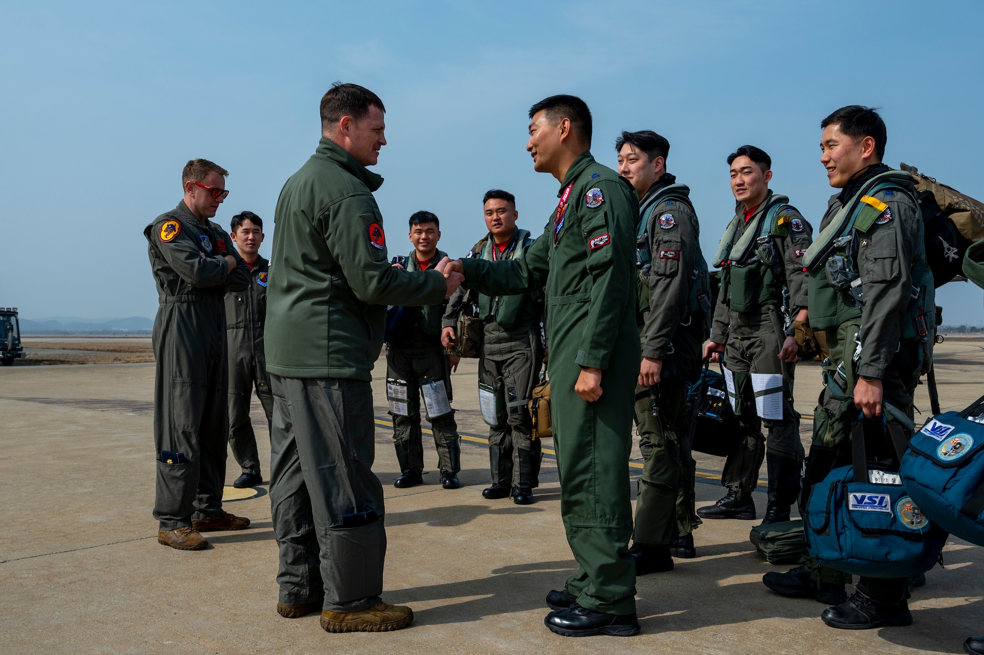 U.S. Air Force Lt. Col. Farrer, 36th Fighter Squadron commander, greets Republic of Korea Air Force Maj. Youngdo Park, 122nd FS vice commander, during Buddy Squadron 24-2 at Osan Air Base, Republic of Korea, March 4, 2024. ROKAF pilots assigned to the 122nd FS trained with the 36th and 35th FS during the week-long training event.The Buddy Squadron Program fosters objective-based training and improves interoperability between the U.S. and ROKAF fighter squadrons. (U.S. Air Force photo by Senior Airman Kaitlin Frazier)