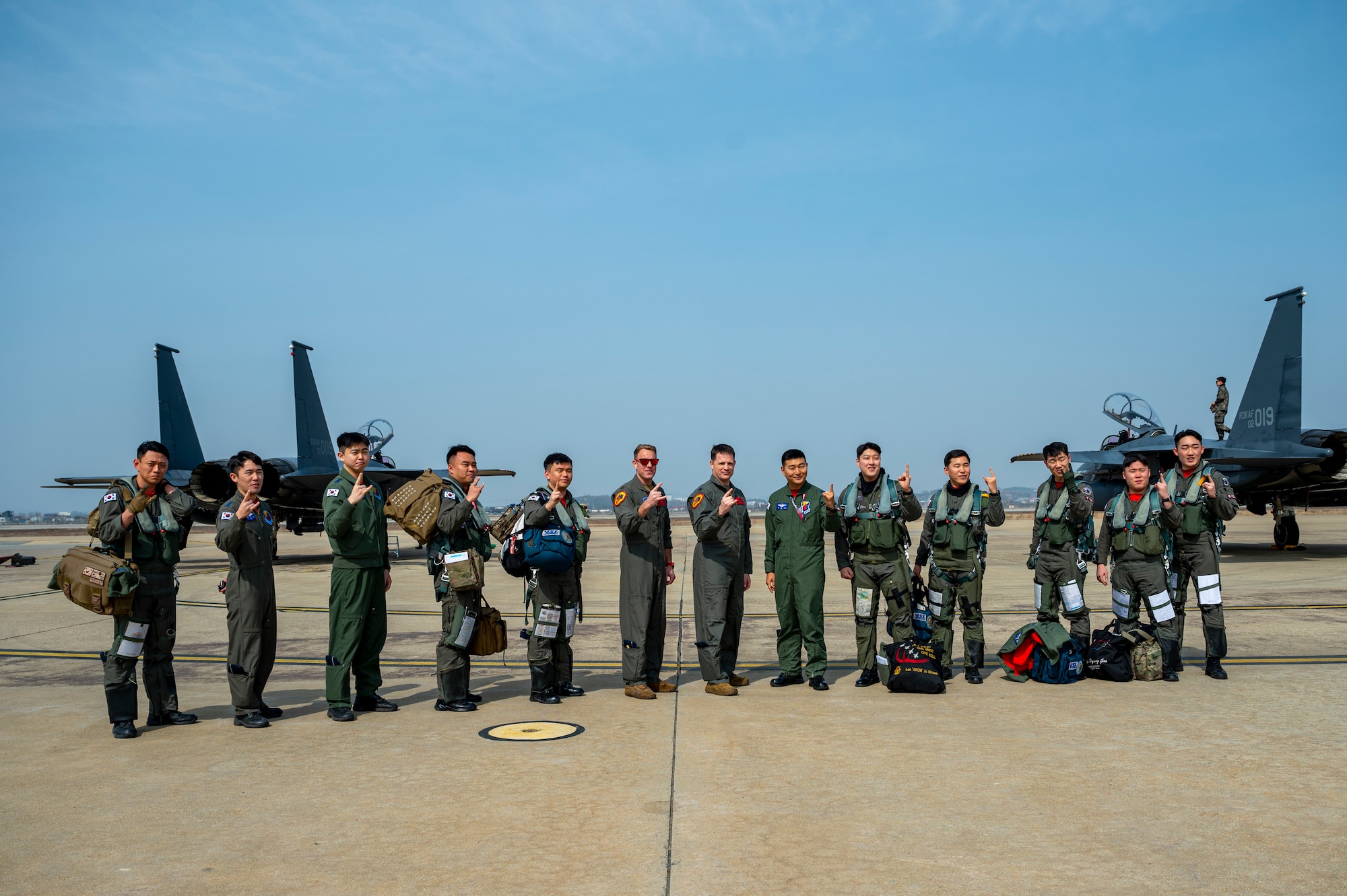 Service members from the U.S. Air Force and the Republic of Korea Air Force pose for a group photo during Buddy Squadron 24-2 at Osan Air Base, Republic of Korea, March 4, 2024. The Buddy Squadron Program allows for bilateral unification, giving more opportunity to train together and ensure lethality and readiness of pilots. The Buddy Squadron Program fosters objective-based training and improves interoperability between the U.S. and ROKAF fighter squadrons. (U.S. Air Force photo by Senior Airman Kaitlin Frazier)