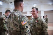 Spc. Alexander Weimer, assigned to Bravo Company, 545th Brigade Engineer Battalion, 45th Infantry Brigade Combat Team, Oklahoma Army National Guard, speaks with Col. Andrew Ballenger, commander of the 45th IBCT, at his Oklahoma Star of Valor ceremony at the Muskogee Armed Forces Reserve Center, Muskogee, Oklahoma, March 3, 2024. Weimer was recognized for his bravery and compassion while assisting civilians involved in a vehicular collision while on his way to drill.