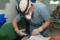 240227-N-FB730-1121 SAN PEDRO SULA, HONDURAS (Feb. 27, 2024) Capt. Jamie Fitch, a general surgeon with Expeditionary Resuscitative Surgical System (ERSS) 11 from Navy Medicine Readiness and Training Command Camp Lejeune, sutures a head laceration in the trauma bay at Hospital Nacional Mario Catarino Rivas, San Pedro Sula, Honduras on Feb. 27, 2024. In collaboration with joint forces and the host nation, Expeditionary Medical Unit 10 G conducted its first Global Health Engagement in Honduras enhances expeditionary core skills and exchanges knowledge with Honduran healthcare professionals in a limited resource environment. (U.S. Navy photo by Mass Communication Specialist 2nd Class Justin Woods)