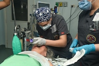 240227-N-FB730-1067 SAN PEDRO SULA, HONDURAS (Feb. 27, 2024) Hospital Corpsman 3rd Class Jessica Powers, a respiratory therapist technician with Expeditionary Medical Facility (EMF) Kilo, intubates a patient in an operating room at Hospital Nacional Mario Catarino Rivas, San Pedro Sula, Honduras on Feb. 27, 2024. In collaboration with joint forces and the host nation, EMF-Kilo conducted its first Global Health Engagement to enhance expeditionary core skills and knowledge exchange with Honduran healthcare professionals in a limited resource environment. (U.S. Navy photo by Mass Communication Specialist 2nd Class Justin Woods)