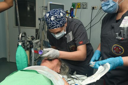 240227-N-FB730-1067 SAN PEDRO SULA, HONDURAS (Feb. 27, 2024) Hospital Corpsman 3rd Class Jessica Powers, a respiratory therapist technician with Expeditionary Medical Facility (EMF) Kilo, intubates a patient in an operating room at Hospital Nacional Mario Catarino Rivas, San Pedro Sula, Honduras on Feb. 27, 2024. In collaboration with joint forces and the host nation, EMF-Kilo conducted its first Global Health Engagement to enhance expeditionary core skills and knowledge exchange with Honduran healthcare professionals in a limited resource environment. (U.S. Navy photo by Mass Communication Specialist 2nd Class Justin Woods)