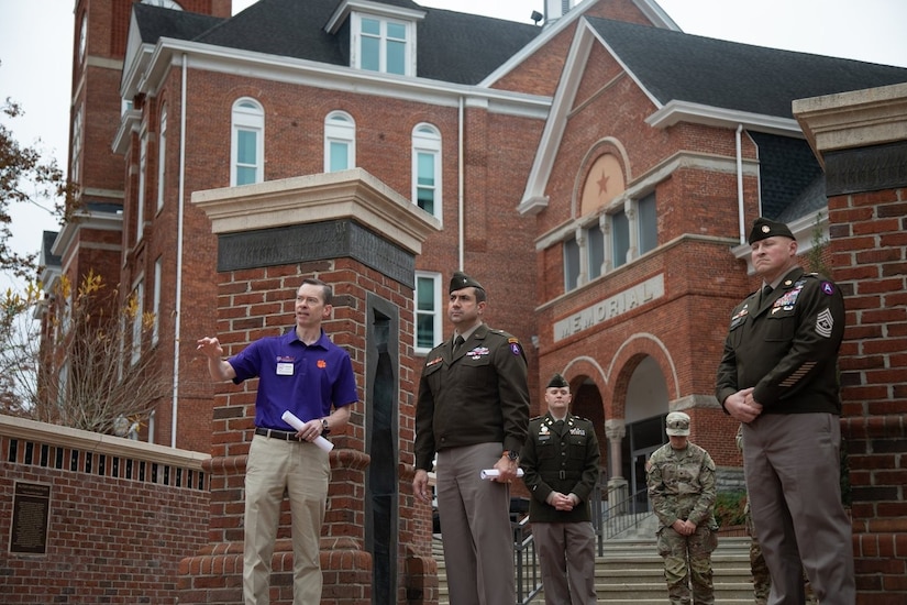 Retired U.S. Air Force Col. Christopher Mann, a professor of management at Clemson and leader of the "Clemson Corps", gives the delegation a history tour of Bowman Field and Tillman Hall from the Military Heritage Plaza on campus.