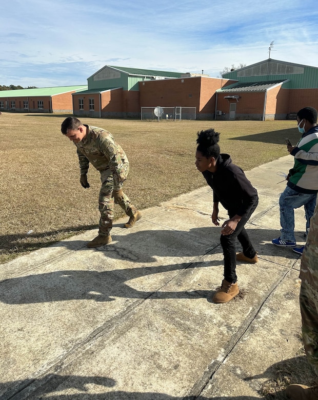 A U.S. Army Central Soldier participates in a foot race with a middle school student during Career Day at Chestnut Oaks Middle School, Sumter