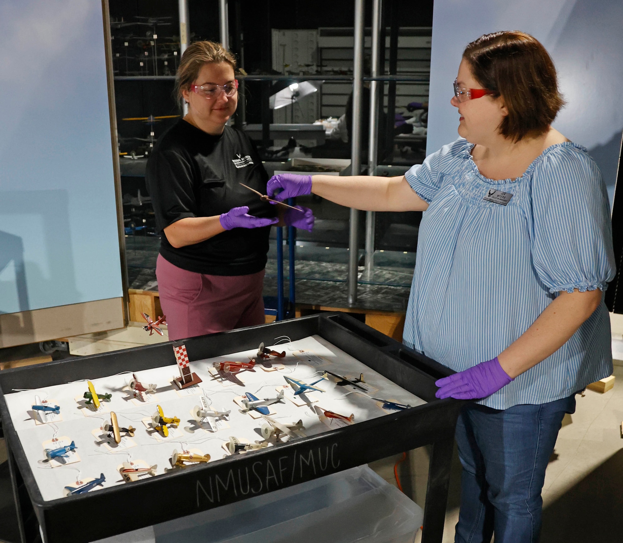 Curator Jacqueline Heiss, left, and Conservator Jennifer Myers from the Collections Division at the National Museum of the U.S. Air Force inspect, catalog and pack model aircraft from the Kettering Model Collection for shipping to the conservation firm ICA in Cleveland, Ohio. After the conservation process has been completed, the 624 model aircraft will be displayed in a new case in the museum's Kettering Hall in the Spring/Summer of 2025.