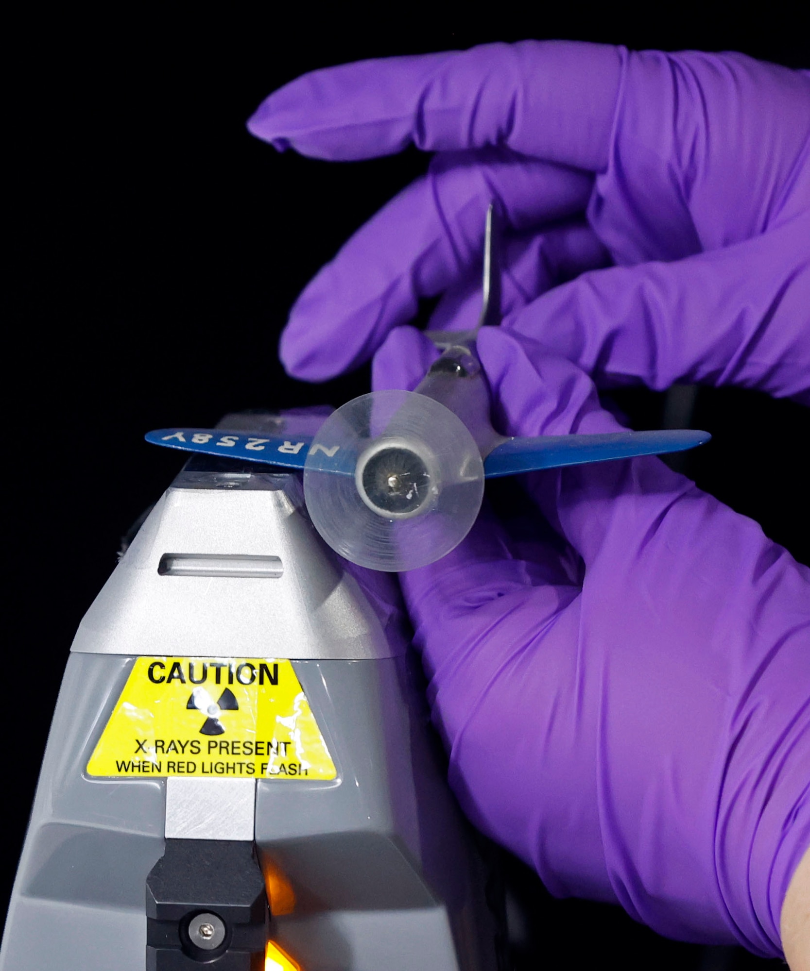 Curator Jacqueline Heiss from the Collections Division at the National Museum of the U.S. Air Force operates an X-ray fluorescence scanner to test for lead paint in model aircraft from the Kettering Model Collection for shipping to the conservation firm ICA in Cleveland, Ohio.