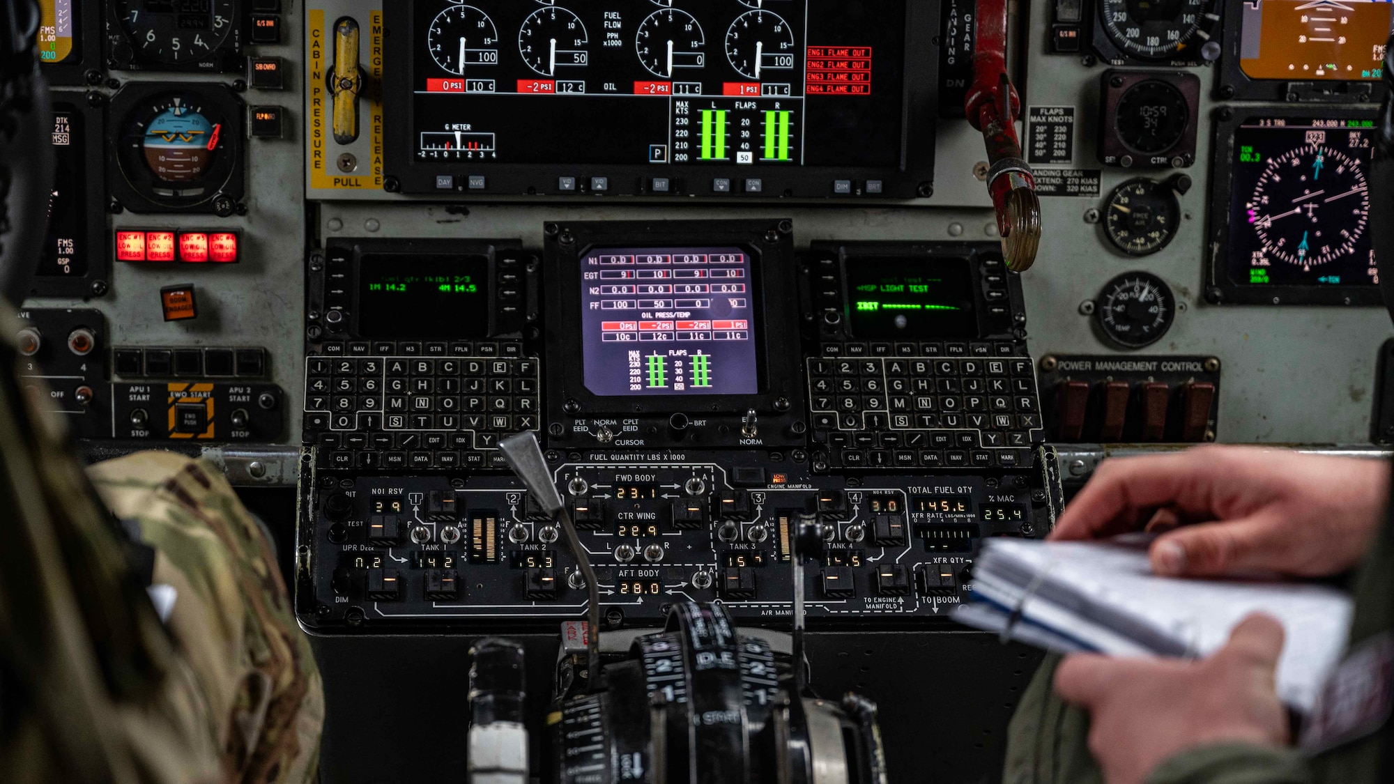 U.S. Air Force KC-135 Stratotanker pilots assigned to the 351st Air Refueling Squadron  read through a pre-flight checklist in preparation for takeoff at Royal Air Force Mildenhall, England, Mar. 7, 2024. Checklists are used to assist pilots with following procedures in a clear and correct manner, ensuring the safety of the aircrew.  (U.S. Air Force photo by Senior Airman Viviam Chiu)