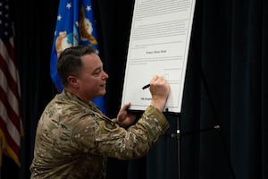 U.S. Air Force Col. Jeremy Bergin, 27th Special Operations Wing commander, signs the Women’s History Month proclamation at Cannon Air Force Base, N.M., March 7, 2024. The signing signaled the start of a wing-wide celebration that honors and celebrates the women throughout history and the achievements they’ve made. (U.S. Air Force photo by Tech. Sgt. Kaylee Clark)