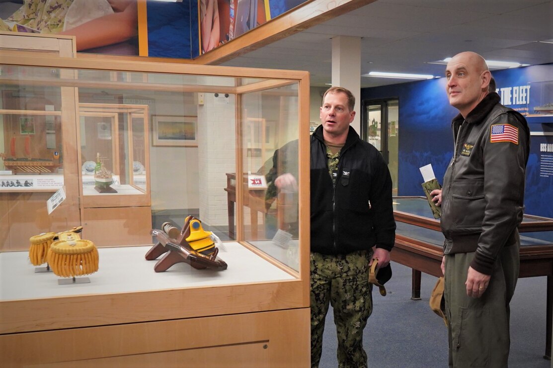 Capt. Henry Roenke (center), commanding officer, Naval Station Newport explains the displays and installation history located in the command headquarters to RDML Wesley McCall, commander, Navy Region Mid-Atlantic during his visit March 7. McCall and members of his staff traveled to Newport to take a closer look at the programs and people providing vital services to the installation mission partners and their team members.