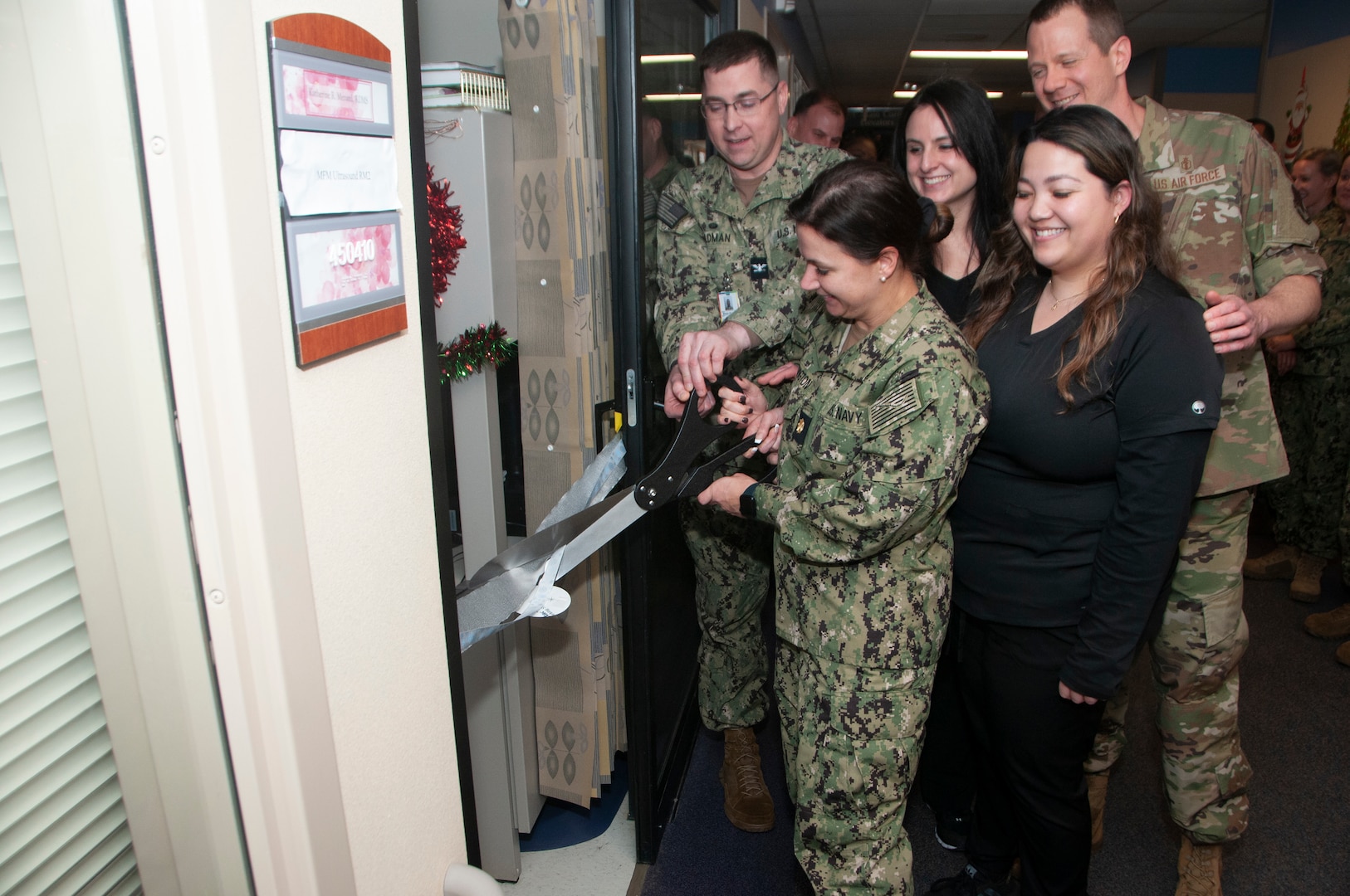 Capt. Brian Feldman, Naval Medical Center Portsmouth (NMCP) director/Navy Medicine Readiness and Training Command (NMRTC) Portsmouth commanding officer, and the Maternal Fetal Medicine Assessment Center team participate in a ribbon cutting ceremony marking the team's first Navy accreditation by the American Institute of Ultrasound in Medicine (AIUM), Dec. 8. (U. S. Navy Photo by W. Scott Epperson)