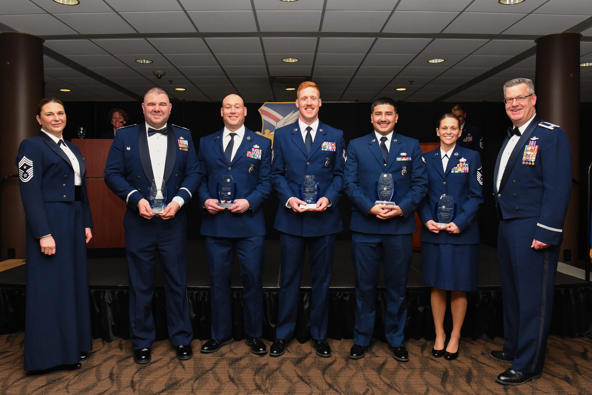 The 910th Airlift Wing’s 2023 Airman of the Year winners pose for a photo with 910th Airlift Wing Commander Col. Michael Maloney (right) and 910th AW Command Chief Master Sgt. Jennifer McKendree (left) during the unit’s annual awards banquet, March 2, 2024, at Youngstown Air Reserve Station, Ohio.