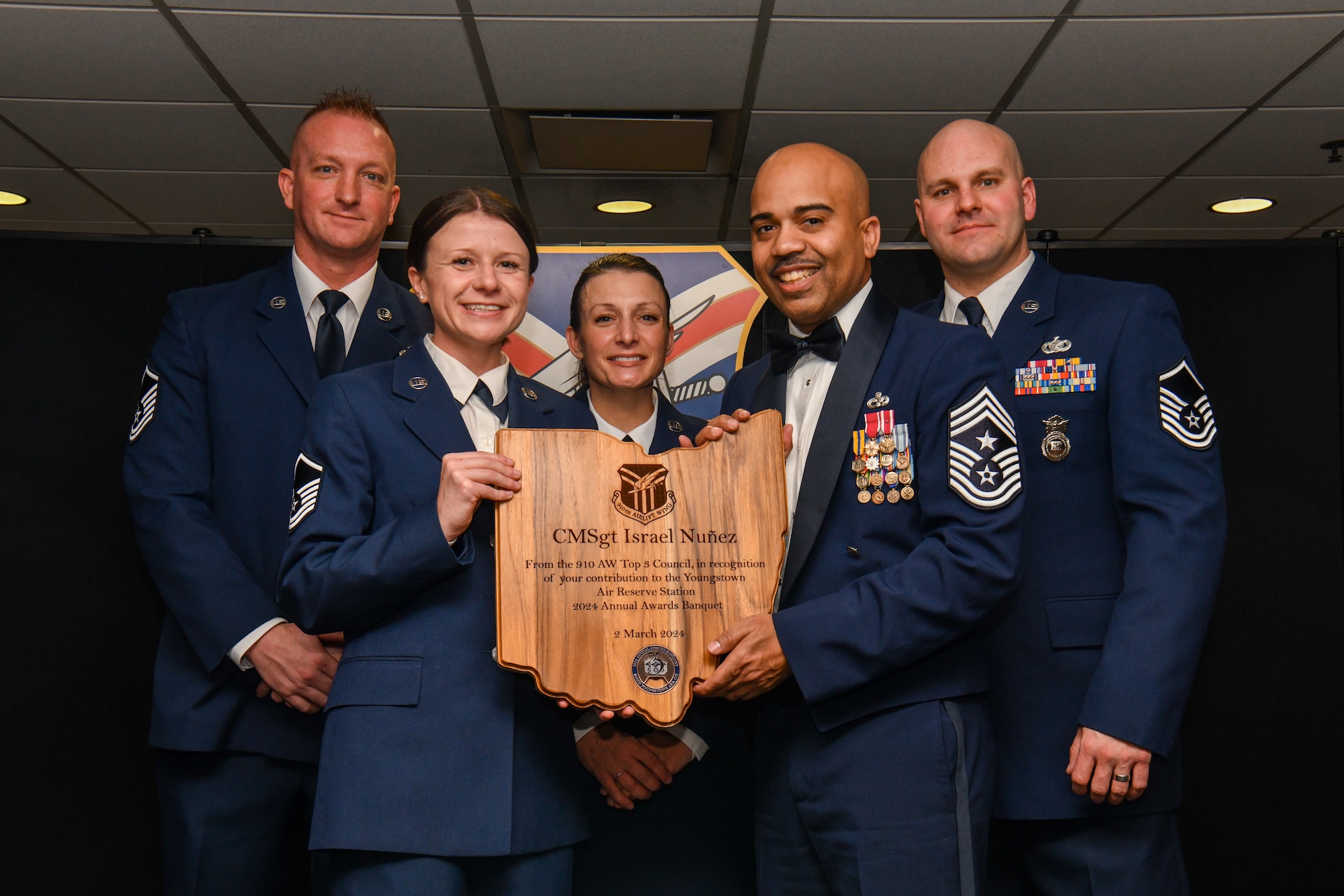 Chief Master Sgt. Israel Nuñez, senior enlisted advisor to the Chief of Air Force Reserve and Command Chief Master Sergeant of Air Force Reserve Command, poses for a photo with Airmen from the 910th AW Top 3 Council, recognizing his contribution to the unit’s annual awards banquet, March 2, 2024, at Youngstown Air Reserve Station, Ohio.