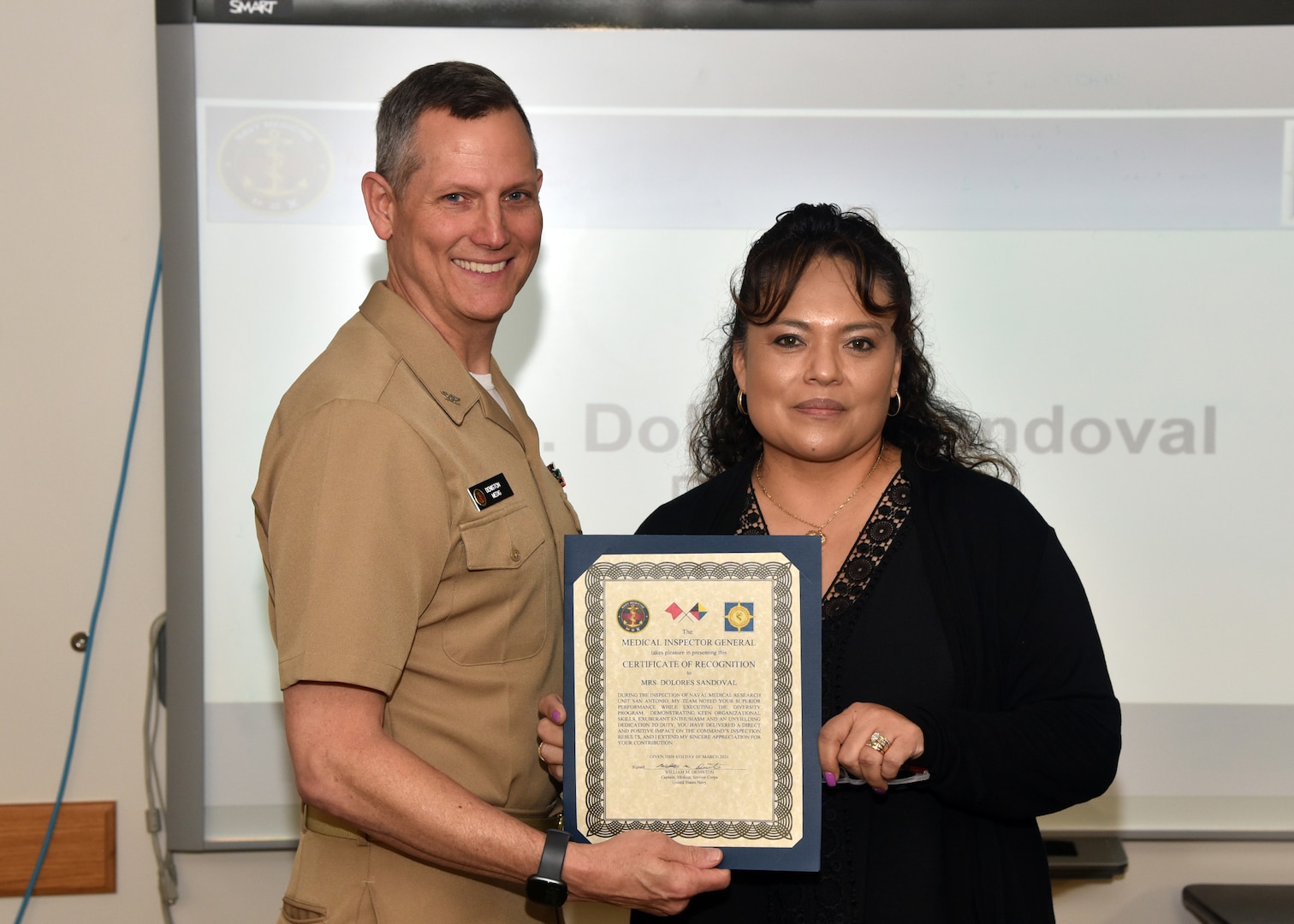 JOINT BASE SAN ANTONIO-FORT SAM HOUSTON – (March 6, 2024) – Dolores Quinones-Sandoval, executive assistant to the commanding officer, Naval Medical Research Unit (NAMRU) San Antonio, was recognized by Capt. William Deniston, medical inspector general (MEDIG), U.S. Navy’s Bureau of Medicine and Surgery (BUMED), for her exceptional professionalism and expertise for serving as the program manager for Diversity during the MEDIG outbrief held at the Battlefield Health and Trauma Research Institute. Approximately 12 inspectors conducted evaluations of 40 programs and collateral duties over three days at Naval Medical Research Unit (NAMRU) San Antonio to improve command performance and processes. NAMRU San Antonio’s mission is to conduct gap driven combat casualty care, craniofacial, and directed energy research to improve survival, operational readiness, and safety of DoD personnel engaged in routine and expeditionary operations. It is one of the leading research and development laboratories for the U.S. Navy under the DoD and is one of eight subordinate research commands in the global network of laboratories operating under the Naval Medical Research Command in Silver Spring, Md. (U.S. Navy photo by Burrell Parmer, NAMRU San Antonio Public Affairs/Released)