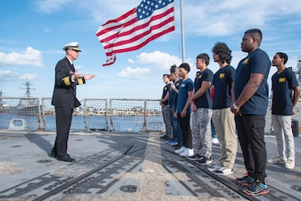 Rear Adm. James Aiken speaks to future Sailors aboard USS Delbert D. Black (DDG 119) at Naval Station Mayport.