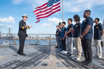 Rear Adm. James Aiken speaks to future Sailors aboard USS Delbert D. Black (DDG 119) at Naval Station Mayport.