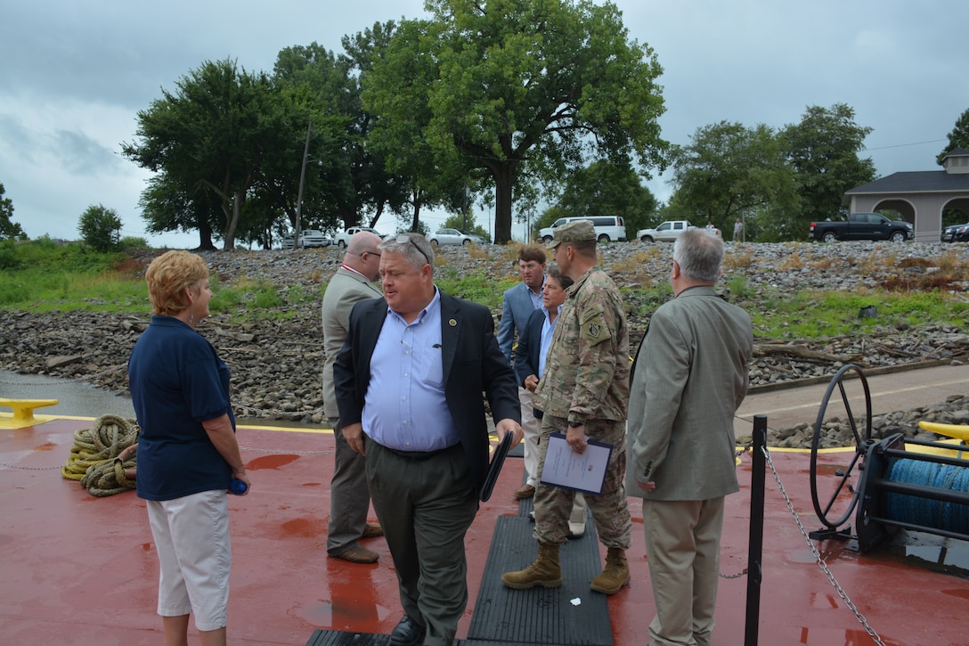 Mississippi River Commission members and staff boarding the M/V Mississippi during a low water inspection trip.  The Commission just left a site visit to the Caruthesville Floodwall during one of the MRC low water inspection trips.  Reynolds Park is in the background.