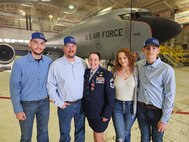 Chief Master Sgt. Amanda G. Stewart, of Nokomis, Illinois, stands with her family after her retirement ceremony at the 126th Air Refueling Wing Hangar, Scott AFB, Illinois, March 3.