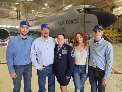 Chief Master Sgt. Amanda G. Stewart, of Nokomis, Illinois, stands with her family after her retirement ceremony at the 126th Air Refueling Wing Hangar, Scott AFB, Illinois, March 3.