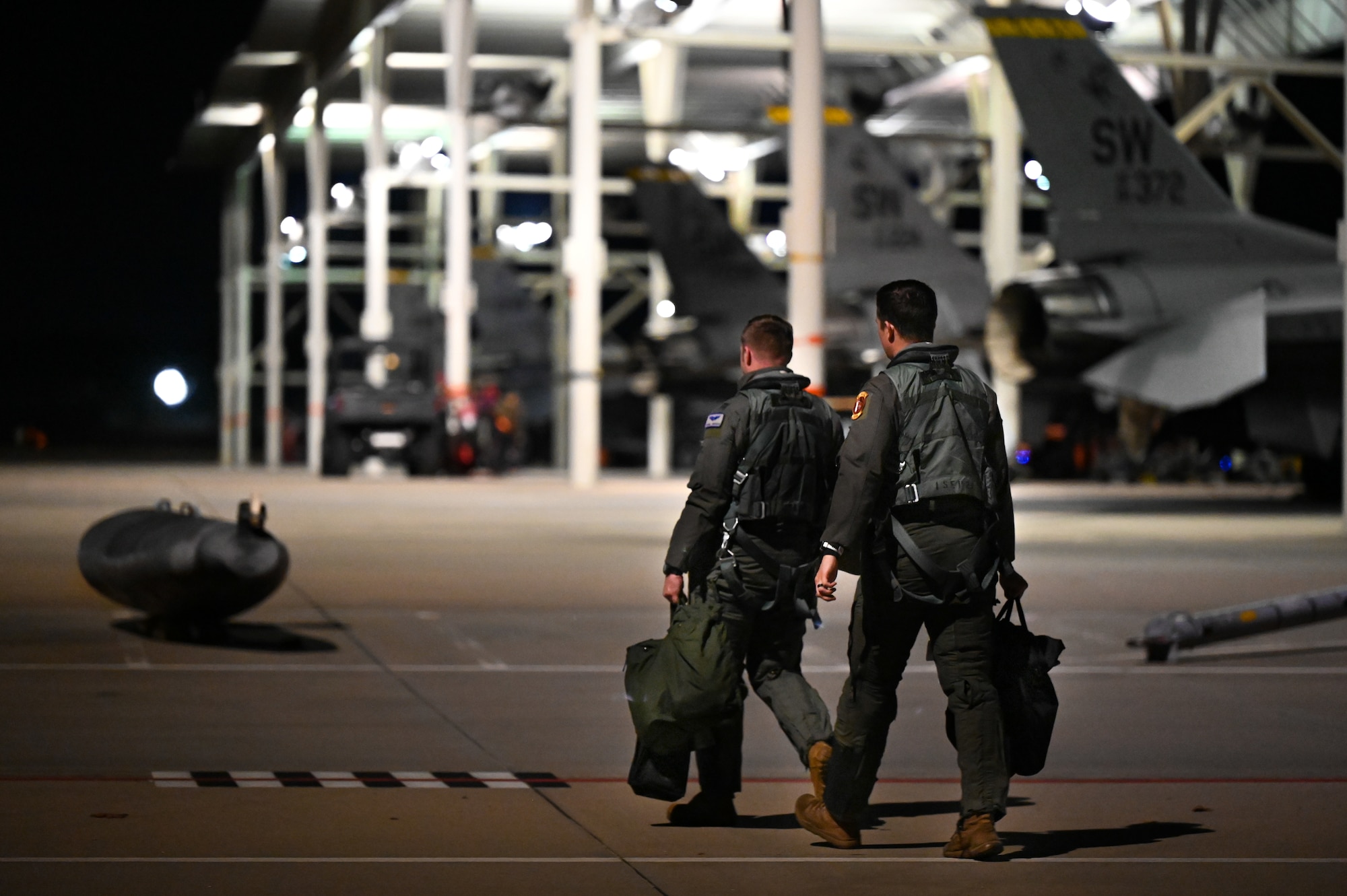 Two pilots walking towards the aircrafts.