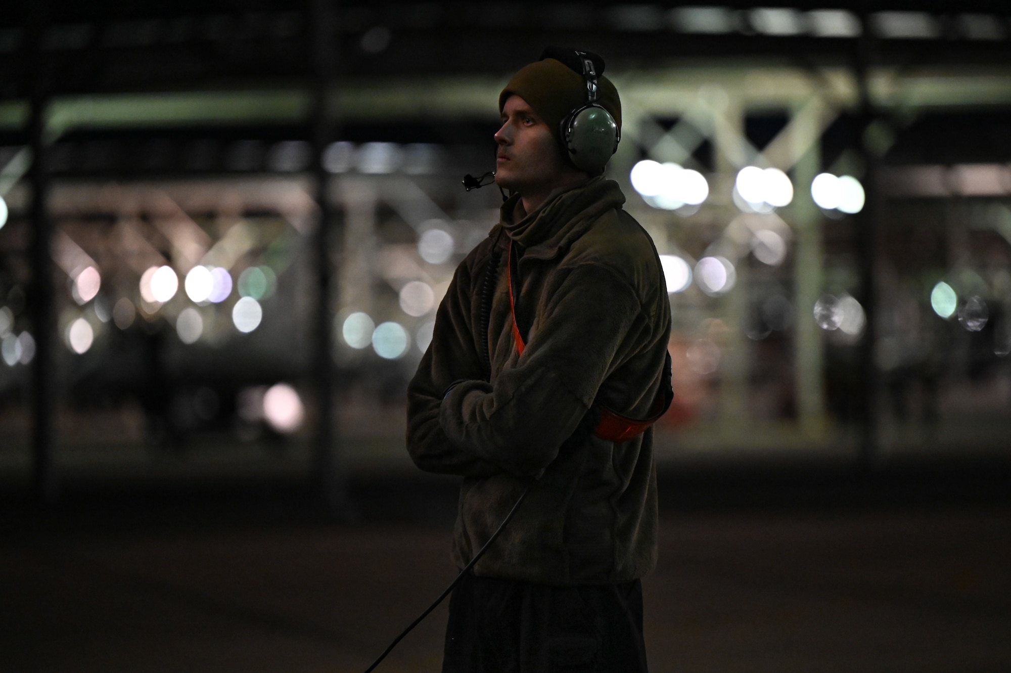 Airman standing with arms crossed.