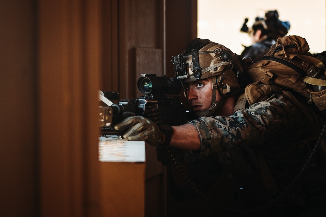 U.S. Marine Corps Lance Cpl. Alexander Lavare, a Tampa, Florida native, infantry Marine with 2nd Battalion, 6th Marine Regiment, 2nd Marine Division, aims down sight on an M240 machine gun during a Marine Air-Ground Task Force Warfighting Exercise as part of Service Level Training Exercise 2-24 at Range 220, Marine Corps Air-Ground Combat Center, Twentynine Palms, California, Feb. 21, 2024. MWX is the culminating event for SLTE 2-24 that improves U.S. and allied service members’ operational capabilities and lethality as a MAGTF. (U.S. Marine Corps photo by Lance Cpl. Richard PerezGarcia)