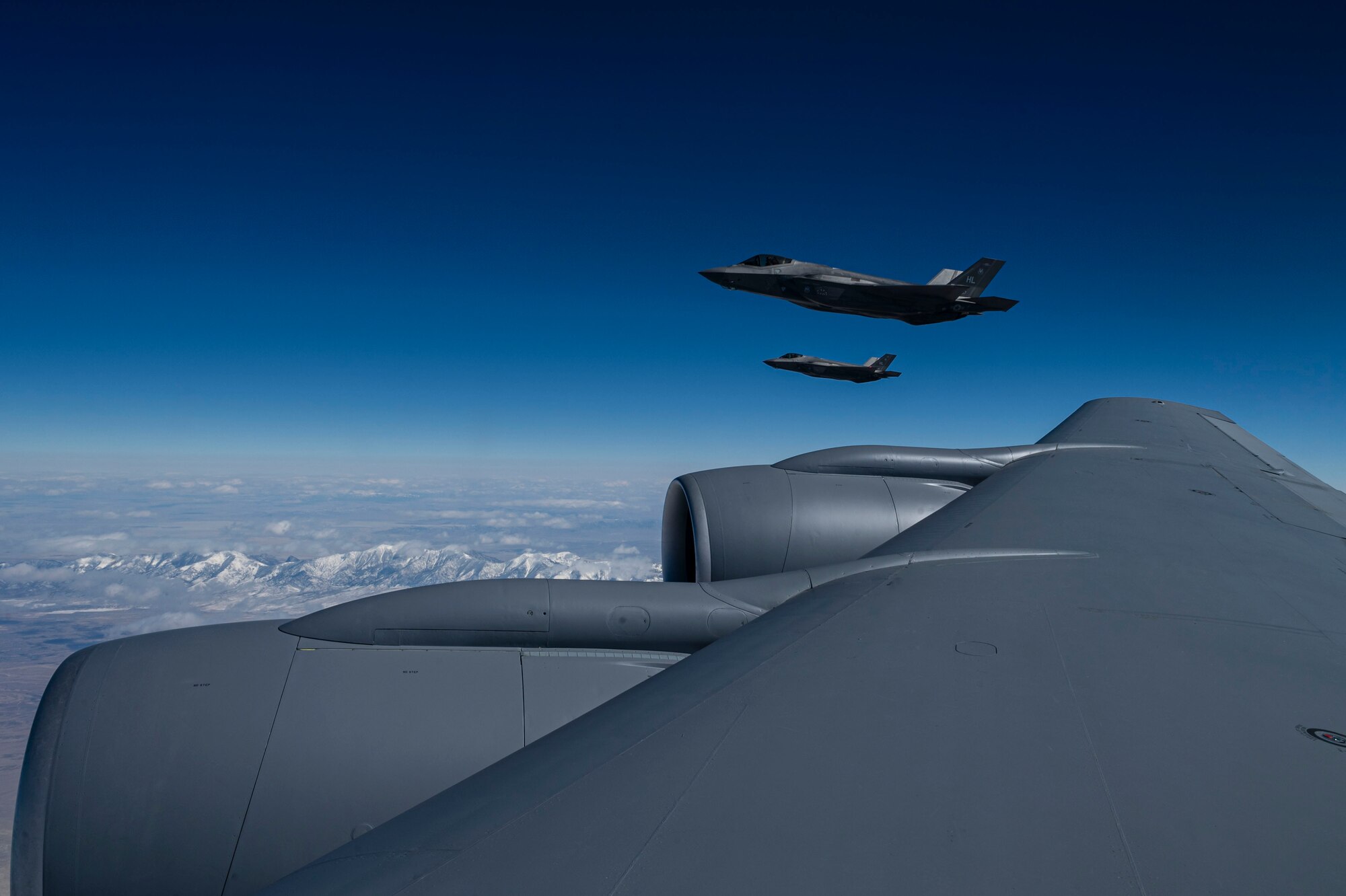 Two F-35 Lightning II’s assigned to Hill Air Force Base, Utah, fly next to a KC-135 Stratotanker assigned to McConnell Air Force Base, Kansas during EXPLODEO Feb. 27, 2024, over the Rocky Mountains. EXPLODEO, a McConnell Air Force Base, Kansas, exercise, tested the 22nd and 931st Air Refueling Wings’ ability to rapidly deploy and employ into a theater. (U.S. Air Force photo by Airman 1st Class Gavin Hameed)