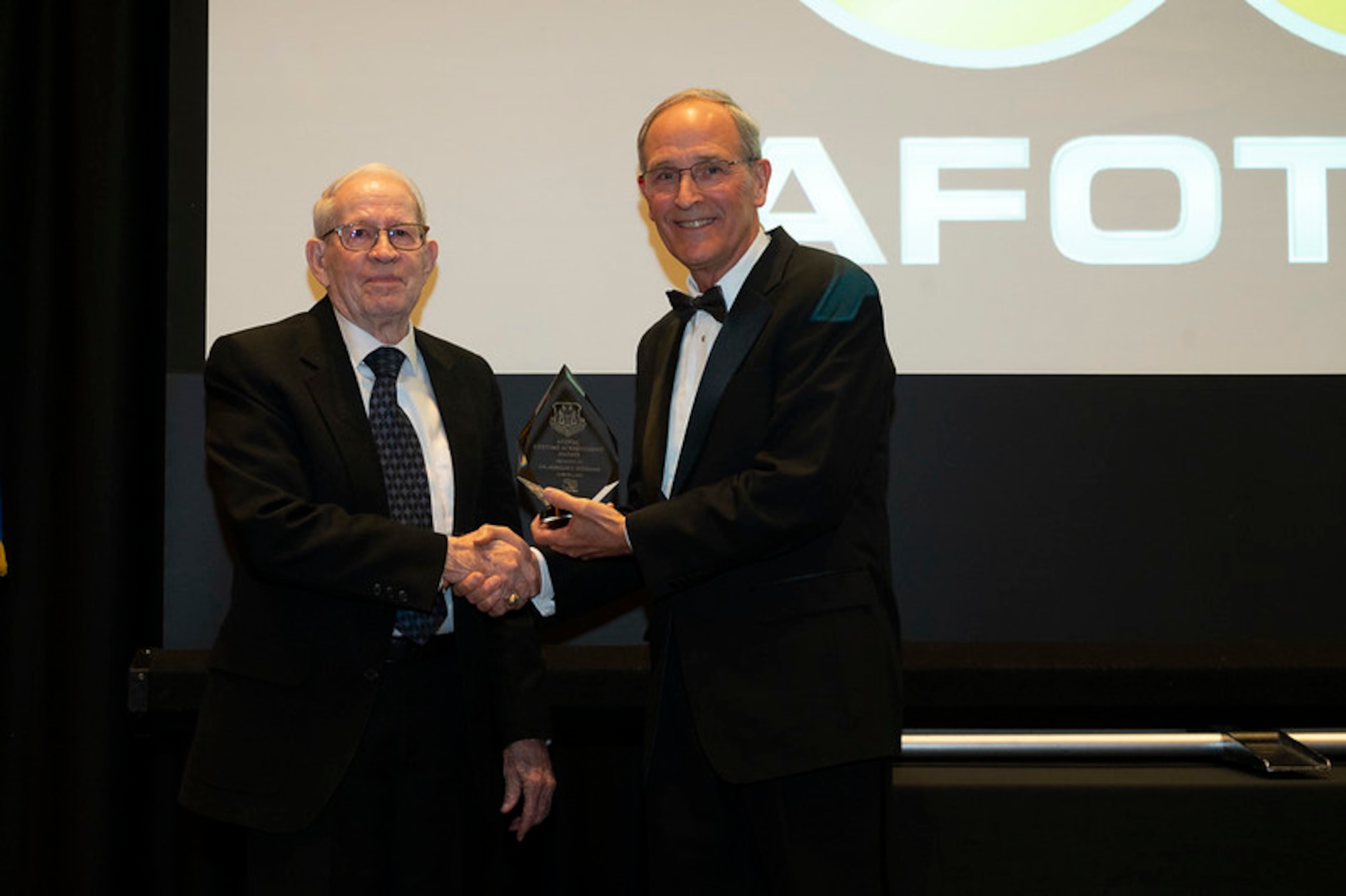 (Right) Jeffrey Olinger, Air Force Operational Test and Evaluation Center Technical Advisor presents the AFOTEC Lifetime Achievement Award to Dr. Marion Williams. Dr. Williams served as AFOTEC’s Chief Scientist and Technical Director from 1974 to 2005.