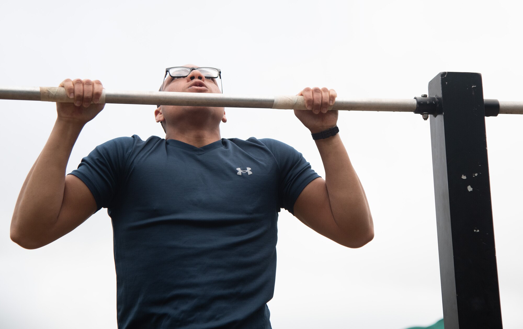 An Airman grips the pull-up bar during the Warrior Day Murph Challenge.