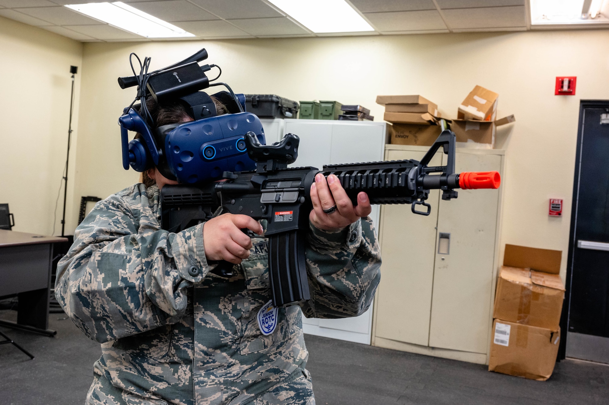 A Westwood High School Air Force Junior Reserve Officer Training Corps student interacts with a virtual reality training simulator employed by the 56th Security Forces Squadron during a base tour, Mar. 7, 2024, at Luke Air Force Base, Arizona.