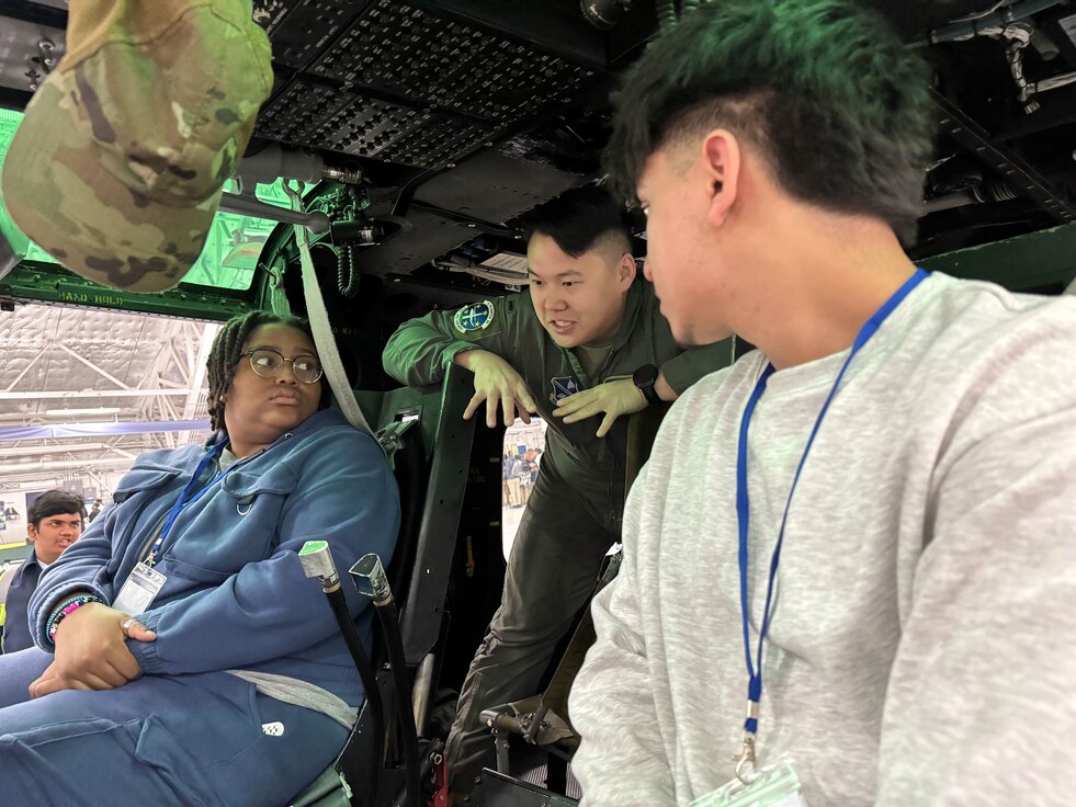 U.S. Air Force 1st Lt. Alex Wang, center, 1st Helicopter Squadron pilot, gives a presentation about the UH-1N Huey helicopter to students during the annual Aerospace Summit at Joint Base Andrews, Md., March 6, 2024.