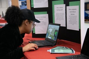 An Oakland Mills High School student tries a drone flying simulator during the annual Aerospace Summit at Joint Base Andrews, Md., March 6, 2024.