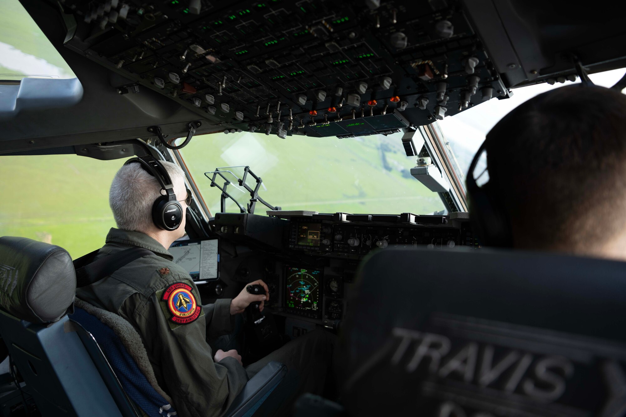 Airmen flying a large military aircraft.