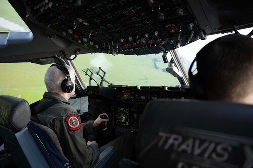 Airmen flying a large military aircraft.