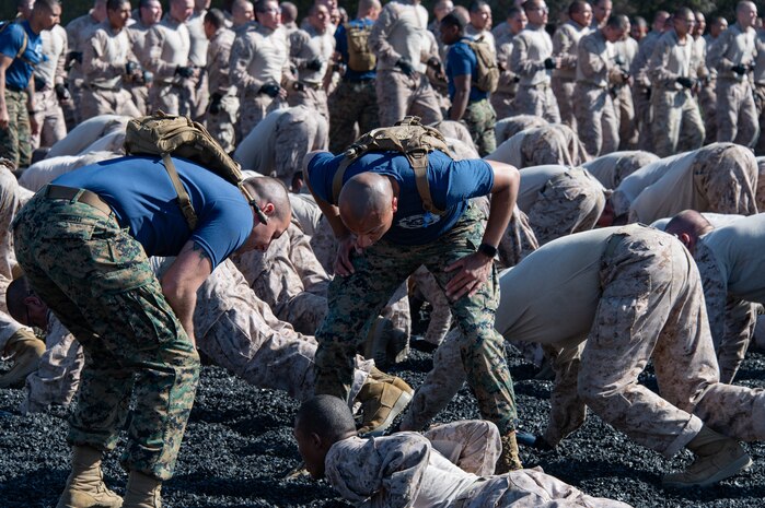 U.S. Marine Corps recruits with Kilo Company, 3rd Recruit Training Battalion, conduct dynamic warm-ups for a Marine Corps Martial Arts Program training event at Marine Corps Recruit Depot San Diego, Mar. 4, 2024. MCMAP aims to strengthen the mental and moral resiliency of individual recruits and Marines through realistic combative training, warrior ethos studies and physical hardening. (U.S. Marine Corps photo by Capt. Charles A. Palmer)