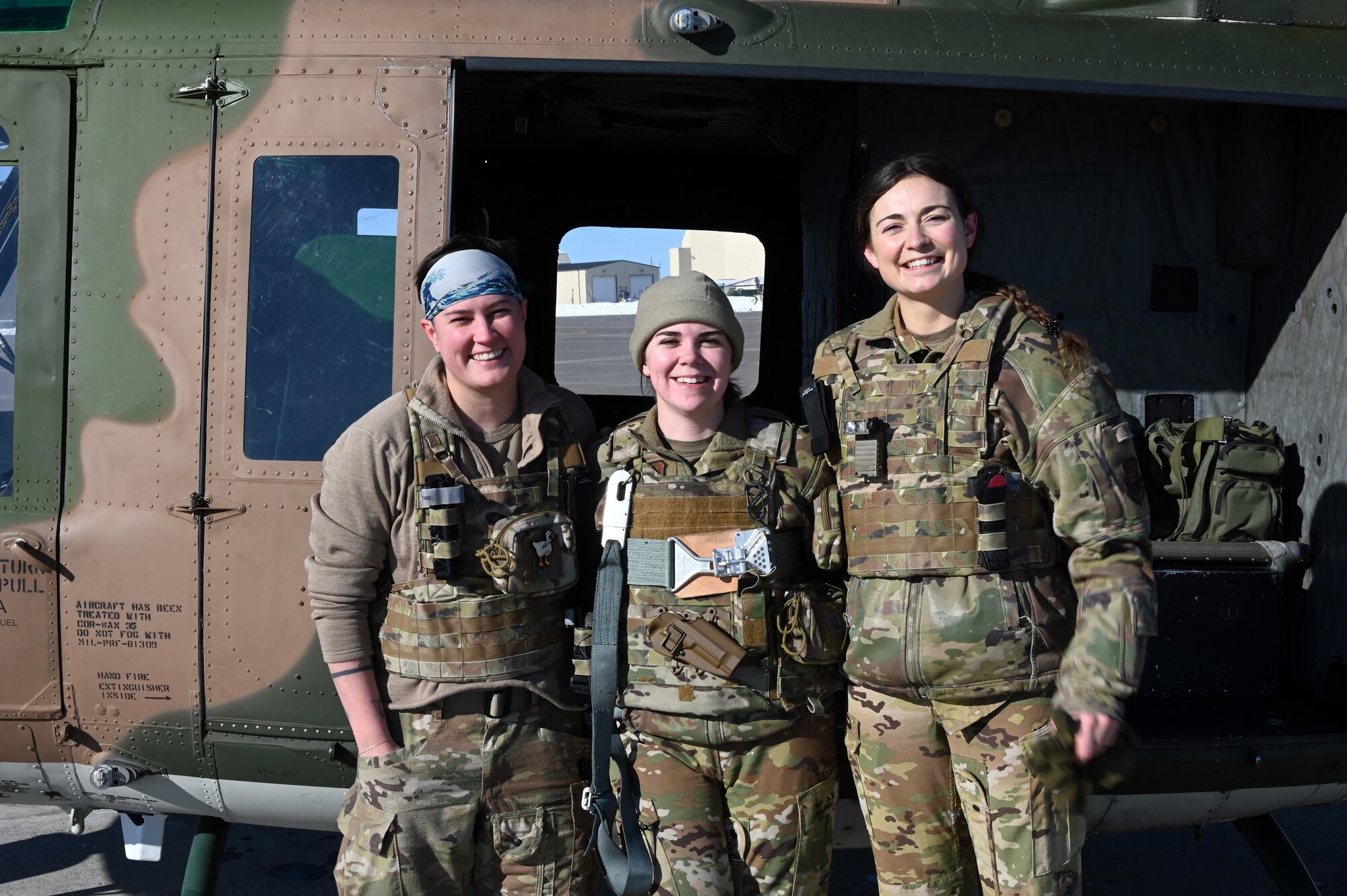 Crew stands outside helicopter