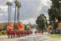 U.S. Marines with Delta Company, 1st Recruit Training Battalion, Recruit Training Regiment, carry the colors during a motivational run at Marine Corps Recruit Depot San Diego, California, Mar. 7, 2024. The motivational run is the last physical training event the Marines will conduct before they graduate from MCRD San Diego and is the first time the friends and families will see their new Marines. (U.S. Marine Corps photo by Lance Cpl. Janell B. Alvarez)