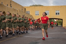 U.S. Marine Corps Sgt. Natasha Ajin, a drill instructor with Delta Company, 1st Recruit Training Battalion, Recruit Training Regiment, calls cadence during a motivational run at Marine Corps Recruit Depot San Diego, California, Mar. 7, 2024. The motivational run is the last physical training event the Marines will conduct before they graduate from MCRD San Diego and is the first time the friends and families will see their new Marines. (U.S. Marine Corps photo by Lance Cpl. Janell B. Alvarez)