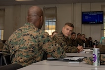 U.S. Marine Corps Sgt. Maj. Idris Turay, left, senior enlisted leader with Marine Aircraft Group 39, 3rd Marine Aircraft Wing and I Marine Expeditionary Force, engages with an attendee of an ethics seminar course at Marine Corps Recruit Depot San Diego, California, Mar. 6, 2024. The ethics seminar is designed to provide train-the-trainer certifications on ethics from the Lejeune Learning Institution and Marine Corps University into entry level training to active-duty service members of MCRDSD. (U.S. Marine Corps photo by Lance Cpl. Janell B. Alvarez)