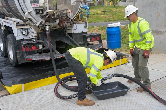 Personnel in support of Joint Task Force-Red Hill (JTF-RH) connect a fuel line to a truck used for moving defueled residual fuel from the Underground Pump House located on Joint Base Pearl Harbor-Hickam (JBPHH), Hawaii, March. 5, 2024