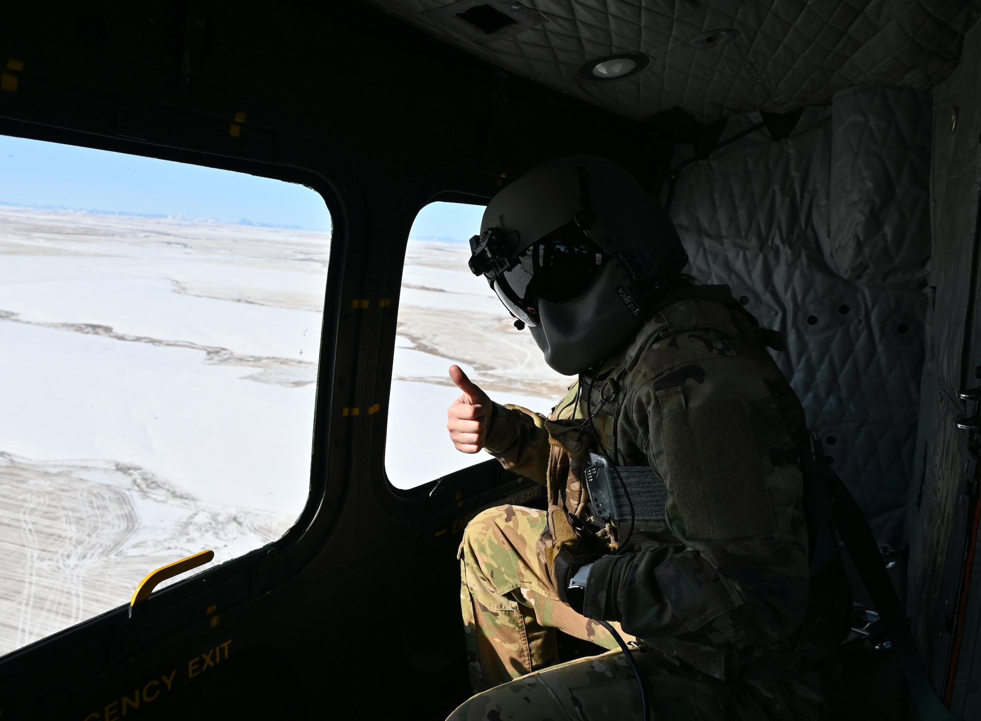Flight engineer poses in helicopter