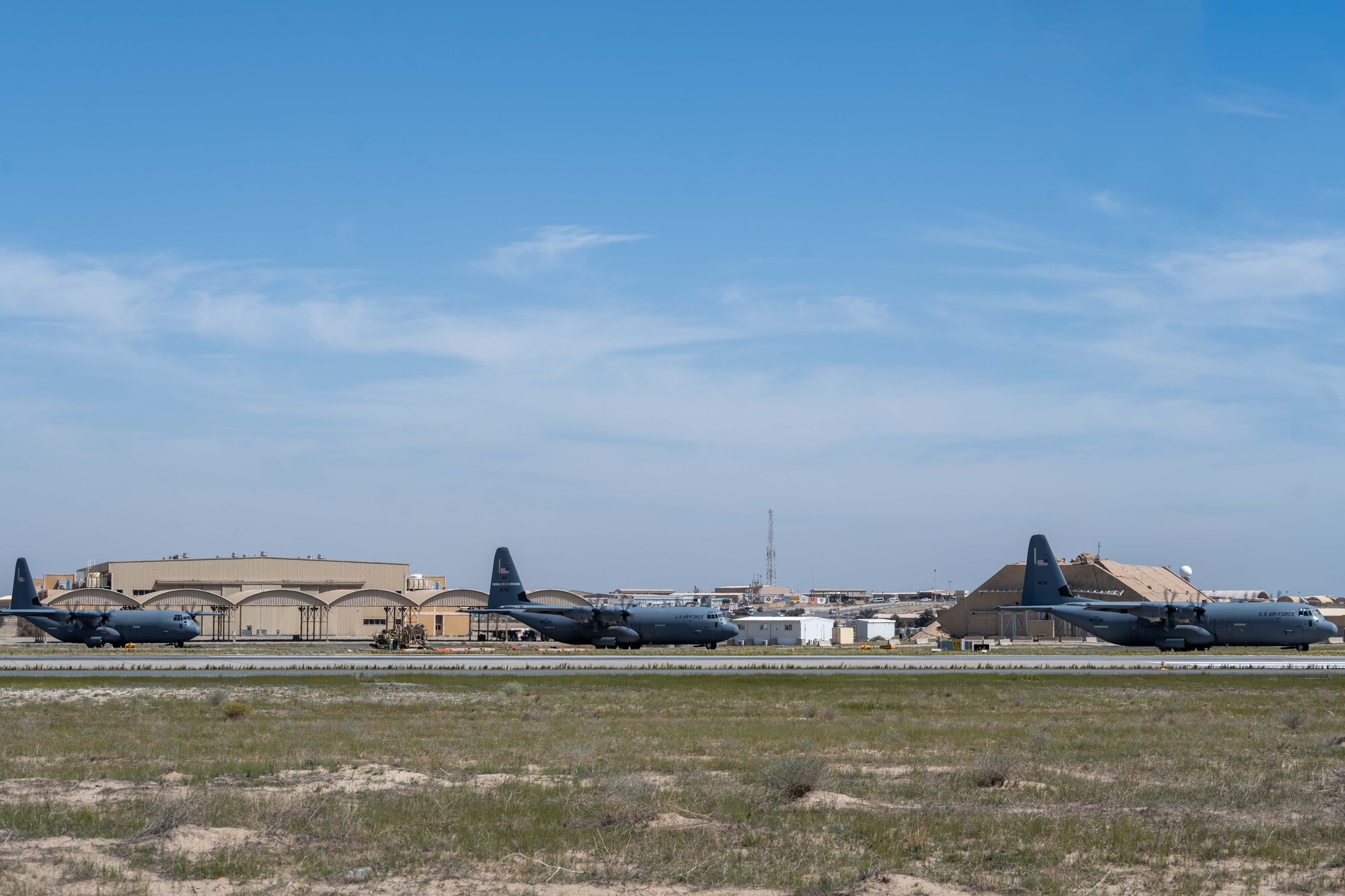C-130s loaded with humanitarian aid bound for airdrop over Gaza taxi to take off from an undisclosed location.