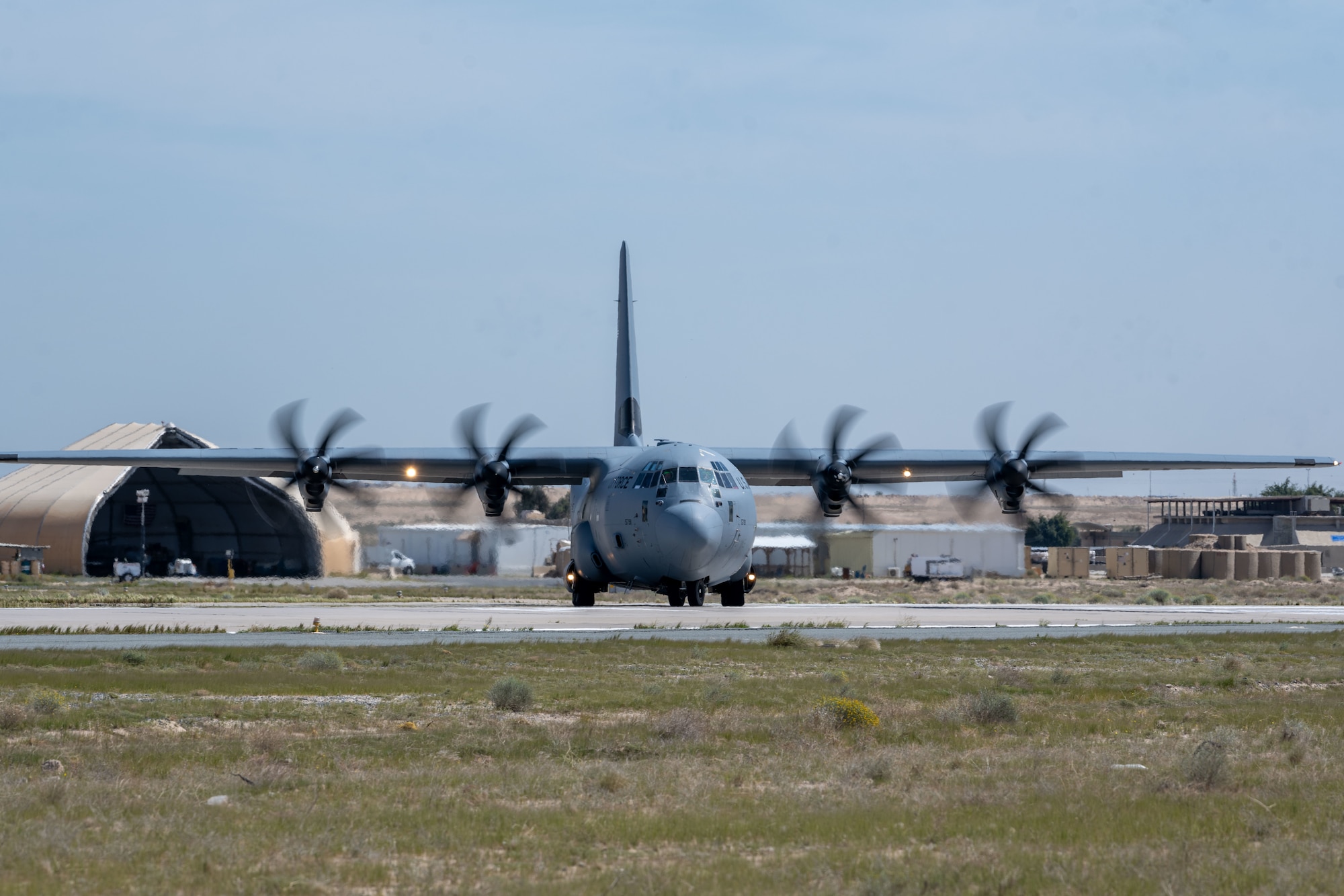 A C-130 loaded with humanitarian aid bound for airdrop over Gaza prepares to take off from an undisclosed location.