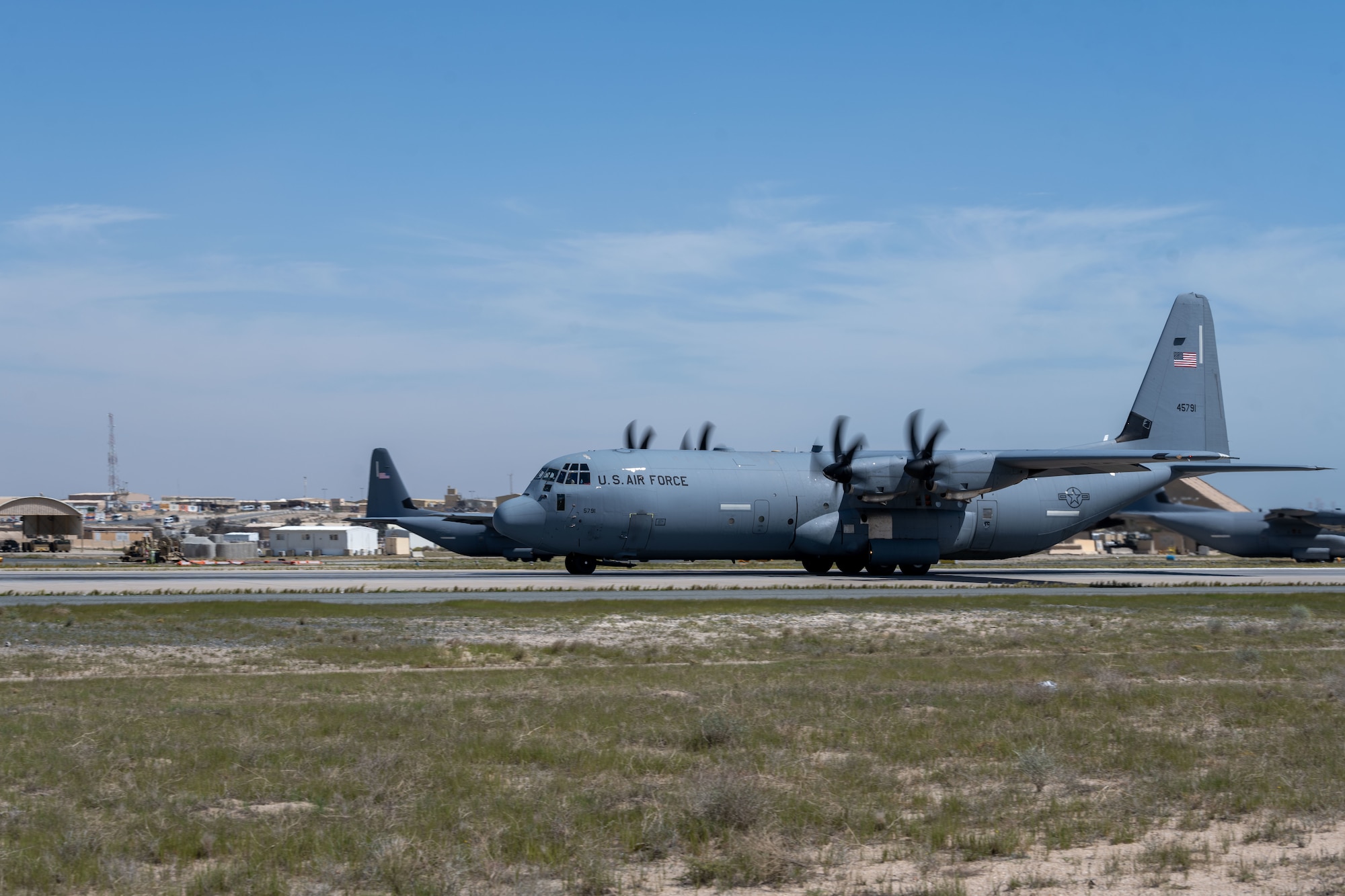 C-130s loaded with humanitarian aid bound for airdrop over Gaza prepare to take off from an undisclosed location.