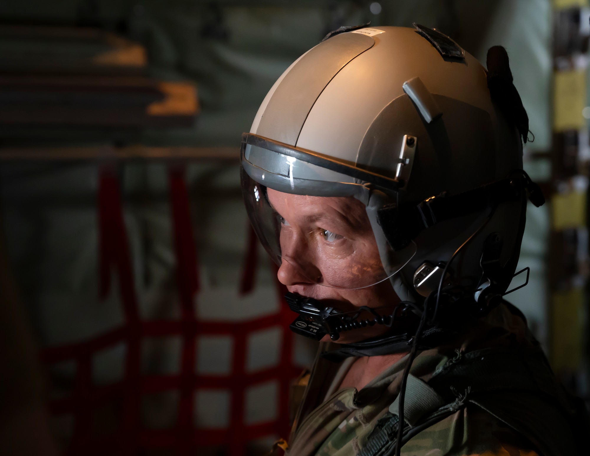 A loadmaster releases humanitarian aid pallets of packaged food and water supplies over Gaza.