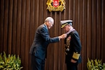 Singapore Minister of Defence Dr. Ng Eng Hen (left) presents Adm. John C. Aquilino, Commander of U.S. Indo-Pacific Command, with the Pingat Jasa Gemilang (Tentera) or Meritorious Service Medal (Military) at the Ministry of Defence headquarters in Singapore on March 7, 2024. Signed by Singapore President Tharman Shanmugaratnam, the award was given for “substantive contributions toward enhancing the strong and longstanding defence relationship between the United States and Singapore” and highlighted Aquilino’s role in increasing regional capacity building efforts, deepening people-to-people ties through inclusivity, and expanding cooperation in the digital domain. (U.S. Navy photo by Chief Mass Communication Specialist Shannon M. Smith)