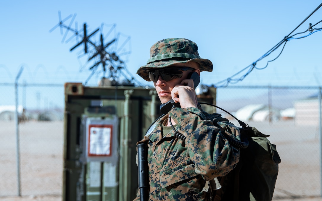 U.S. Marine Corps Pfc. Donovan Tapp, a radio transmissions operator with 3d Marine Littoral Regiment, 3d Marine Division tests communications equipment at Marine Corps Air Ground Combat Center Twentynine Palms, California, Jan. 27, 2023. Marine Littoral Regiment Training Exercise is a large-scale, service-level exercise designed to train, develop, and experiment with the 3d MLR as part of a Marine Air-Ground Task Force, led by 3d Marine Division, operating as a Stand-in Force across a contested and distributed maritime environment. Pfc. Tapp is a native from Tampa, Florida. (U.S. Marine Corps photo by Sgt. Patrick King)