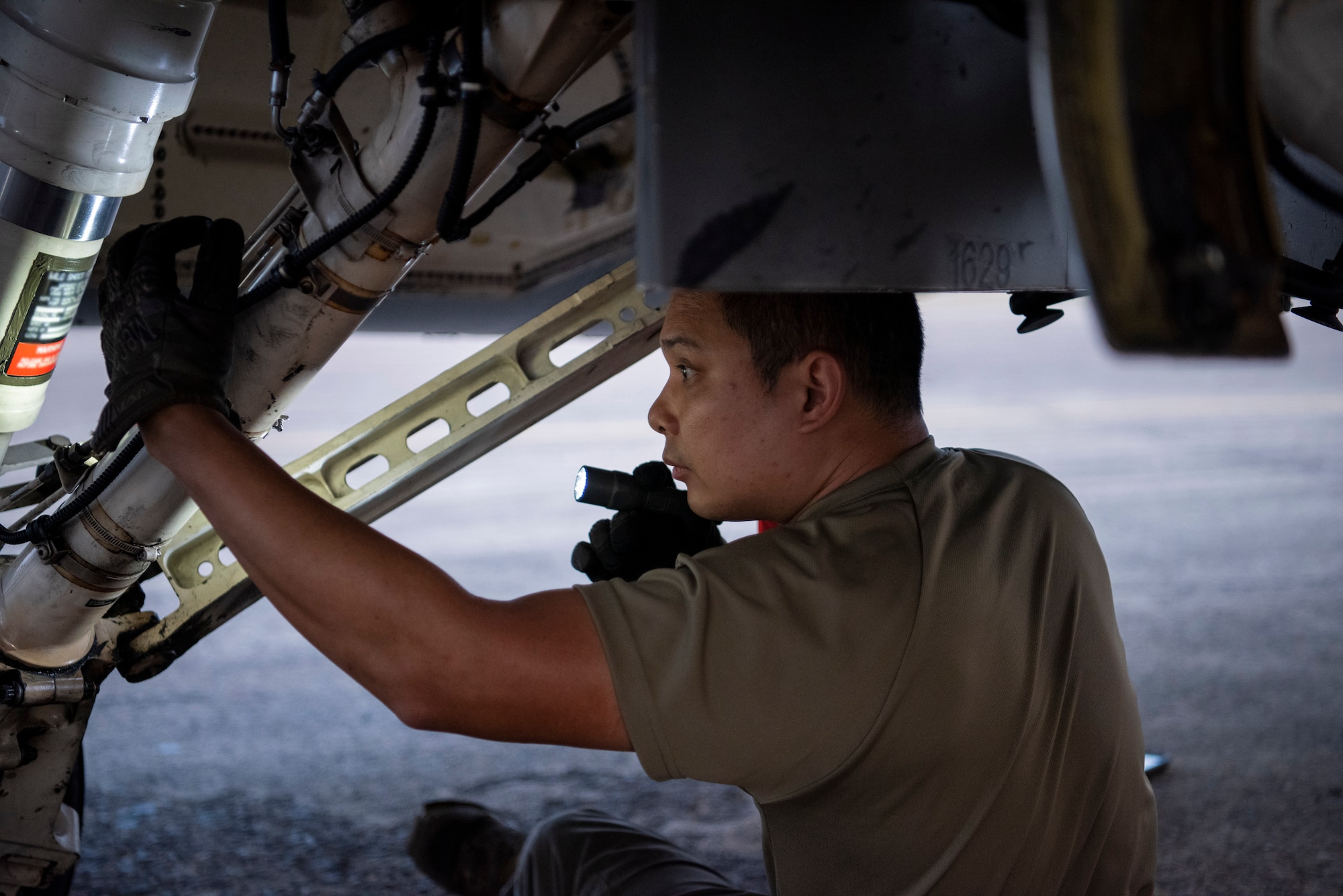Crew chief performs maintenance on an aircraft