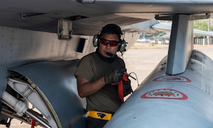 Crew chief performs maintenance on an aircraft